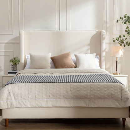 Harper tall upholstered bed with beige fabric headboard and wooden legs on Tampa Home & Garden Store