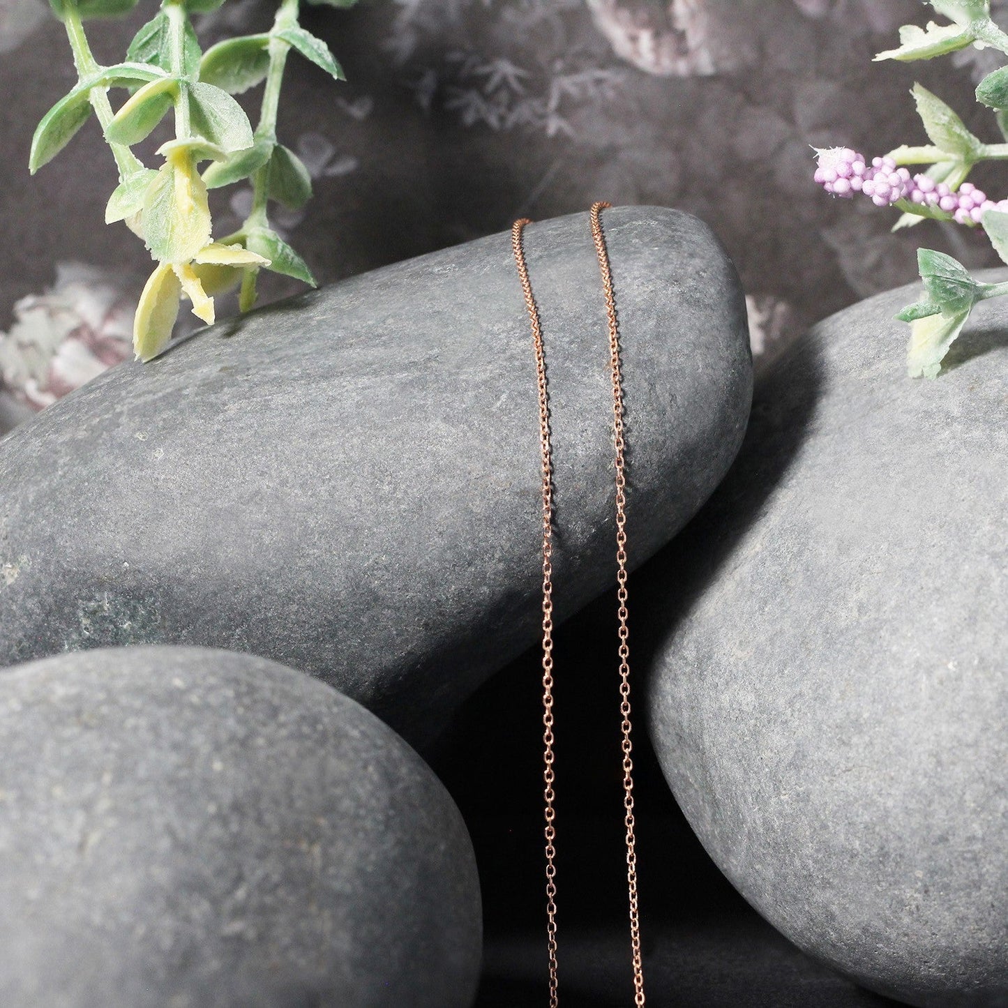 Diamond cut cable link chain necklace in 14k rose gold, two 0.8 mm chains draped over stones on Tampa Home & Garden Store