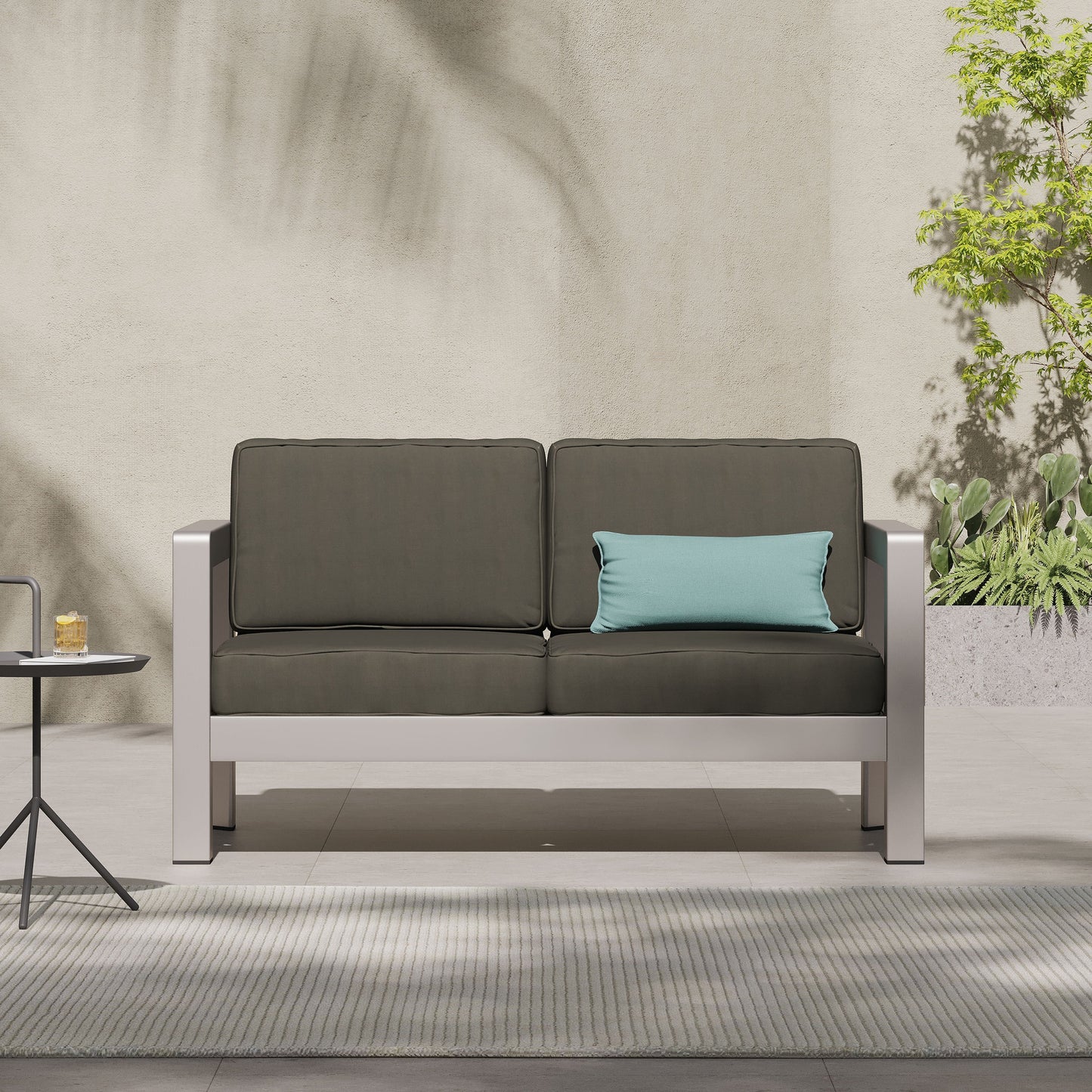 Outdoor aluminum loveseat with deep cushions in dark charcoal for a low-profile patio seating on Tampa Home & Garden Store