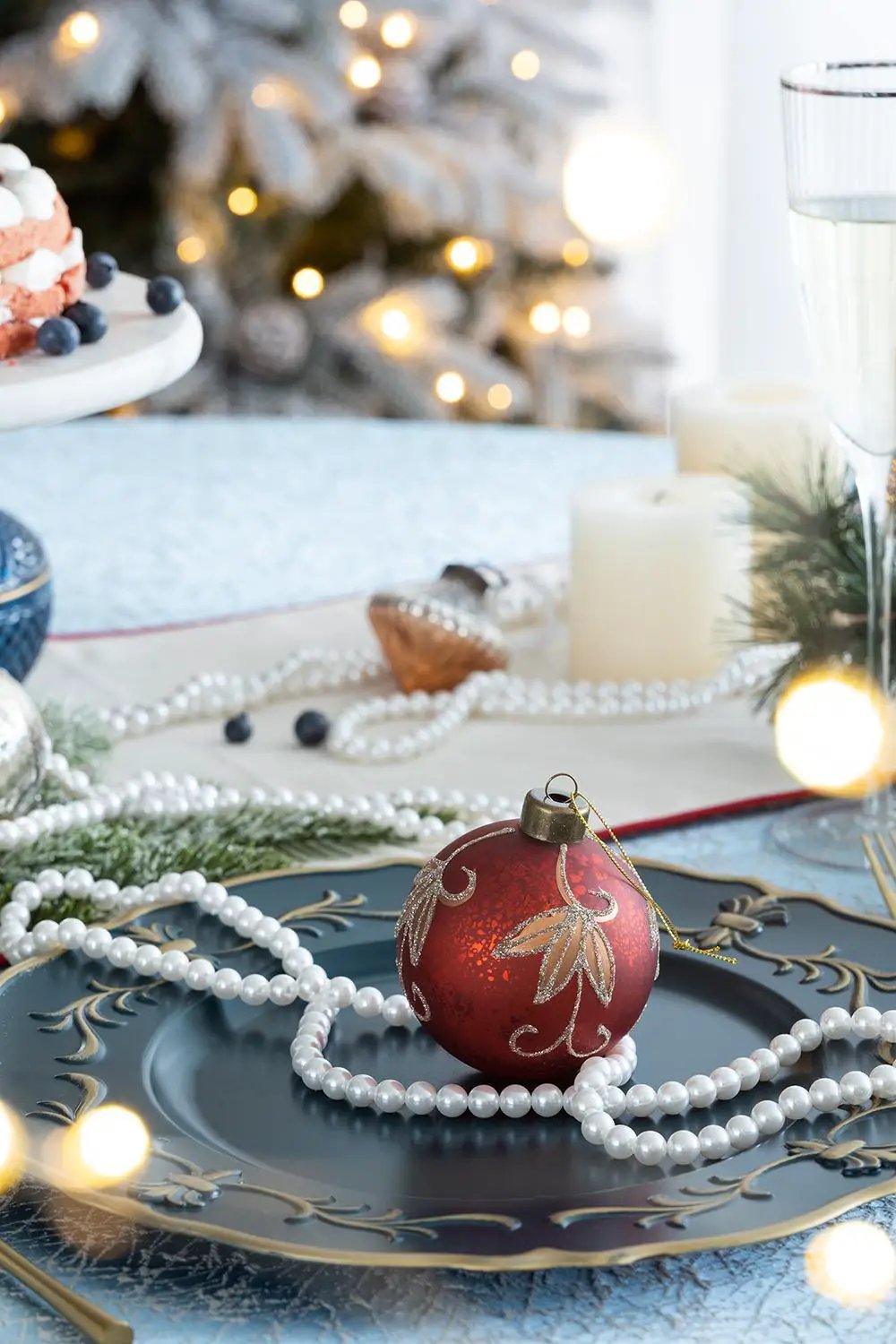 Christmas ball ornament, red with gold glitter leaf pattern on a blue plate, pearl garland on Tampa Home & Garden Store