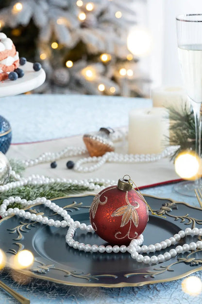 Christmas ball ornament, red with gold glitter leaf pattern on a blue plate, pearl garland on Tampa Home & Garden Store