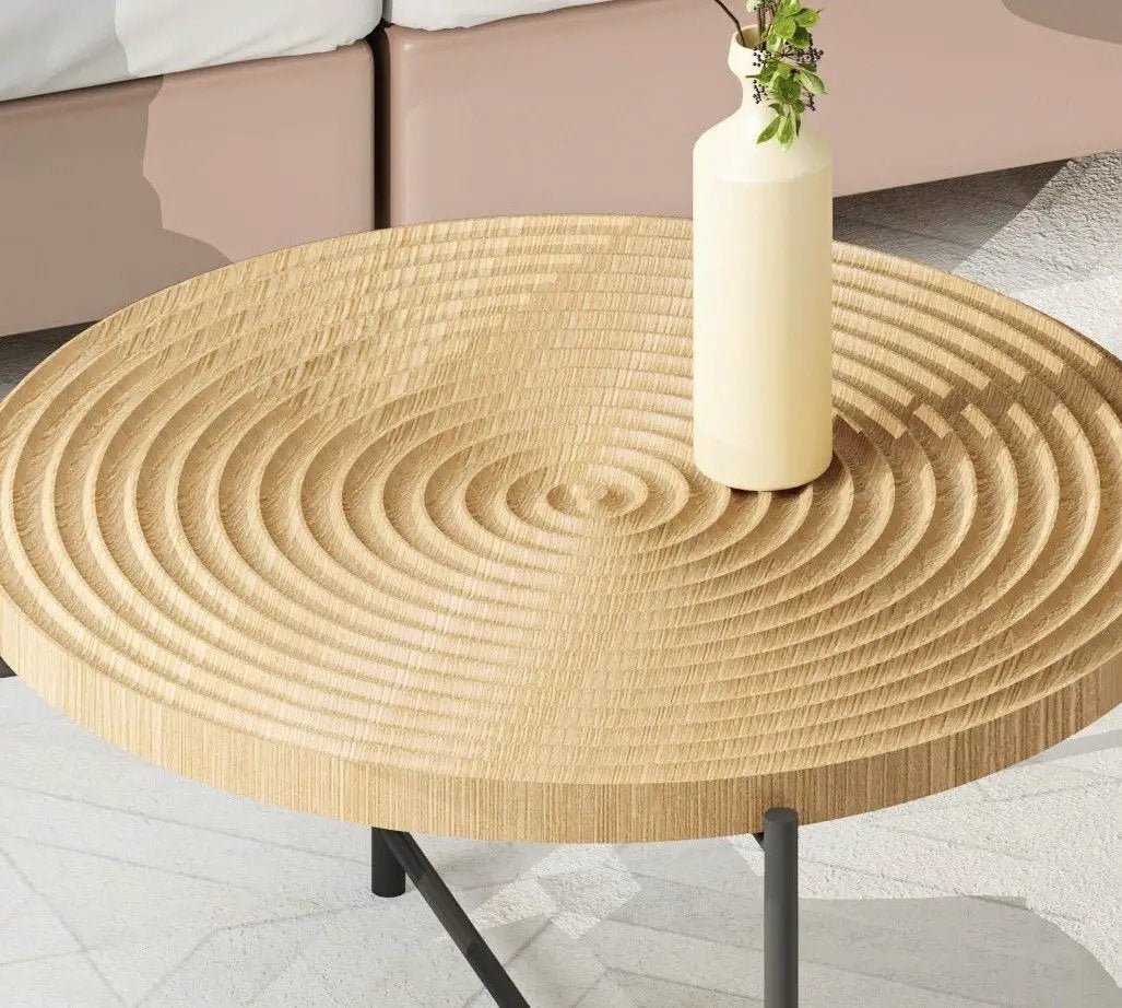 Round wooden coffee table with carved concentric rings and black metal legs on Tampa Home & Garden Store