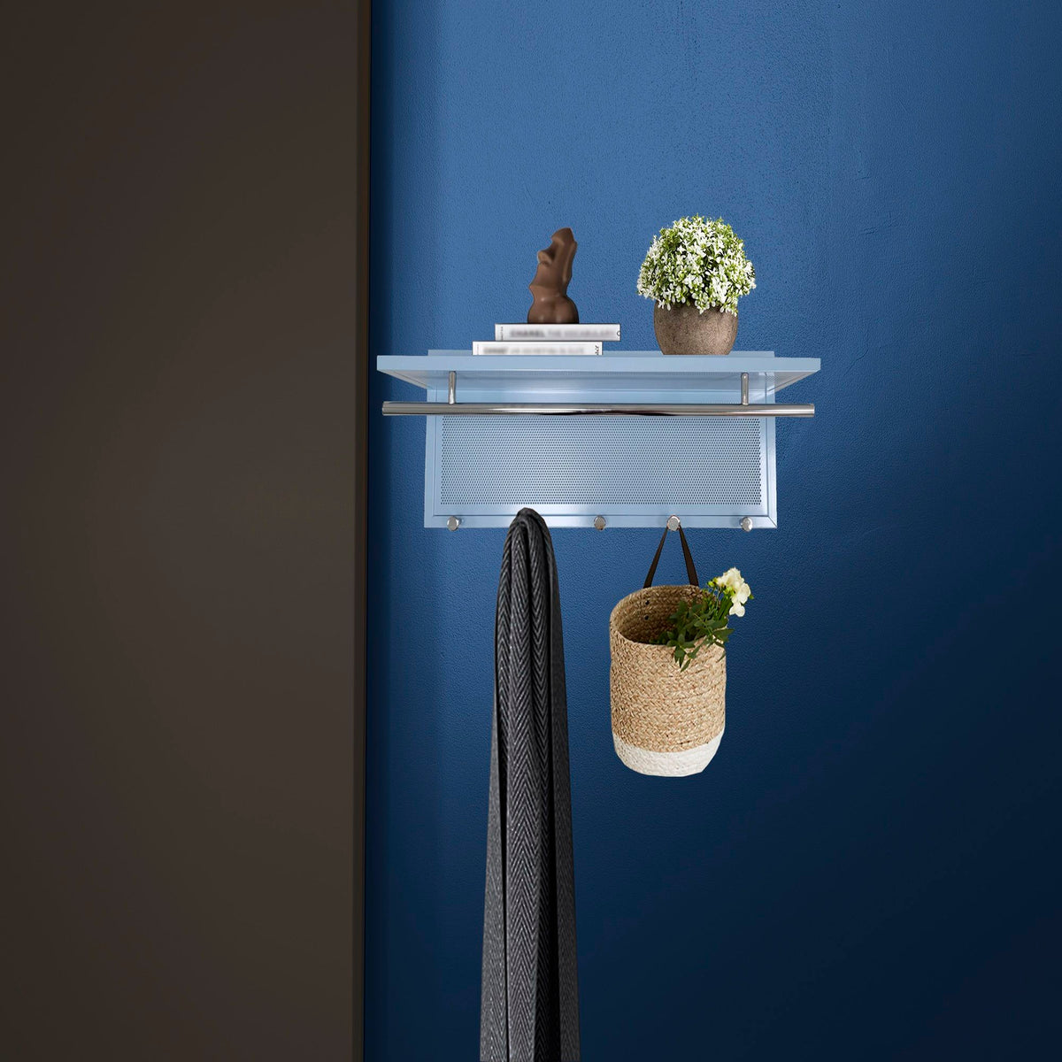 Powder coated metal wall coat rack with blue shelf by HouseOfZazla with books and plant on Tampa Home & Garden Store