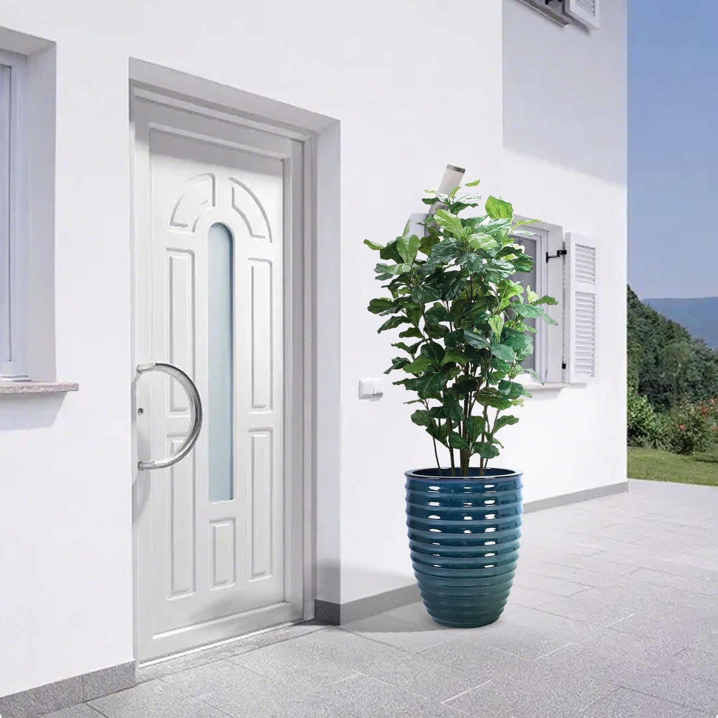 Flowerpot planter in teal ribbed ceramic with leafy plant on white patio on Tampa Home & Garden Store