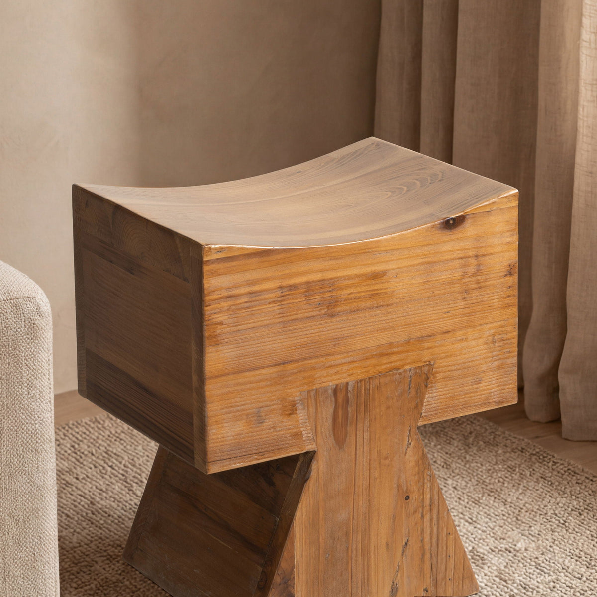 Brown reclaimed wood stool ottoman with sculptural saddle seat, rich grain on Tampa Home & Garden Store