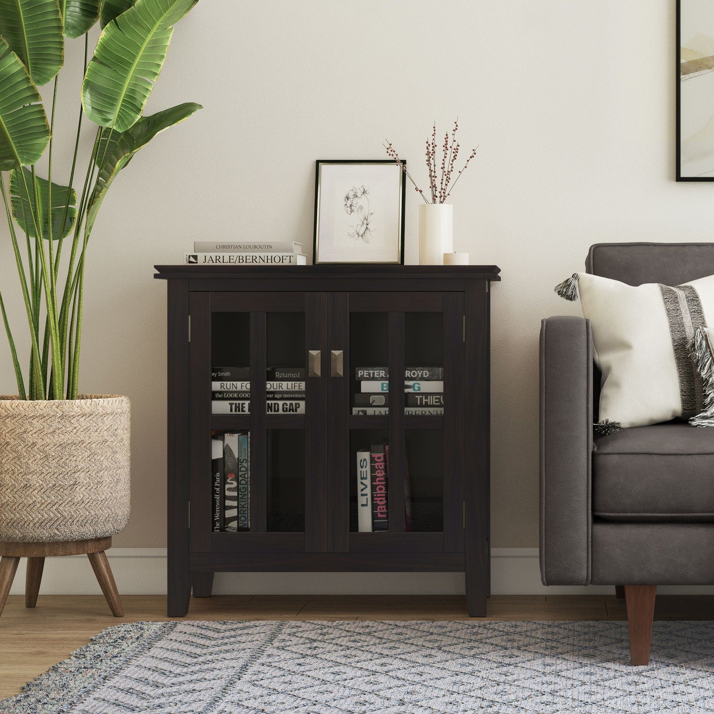 Artisan low storage cabinet Hickory Brown with glass-front panels and books inside on Tampa Home & Garden Store