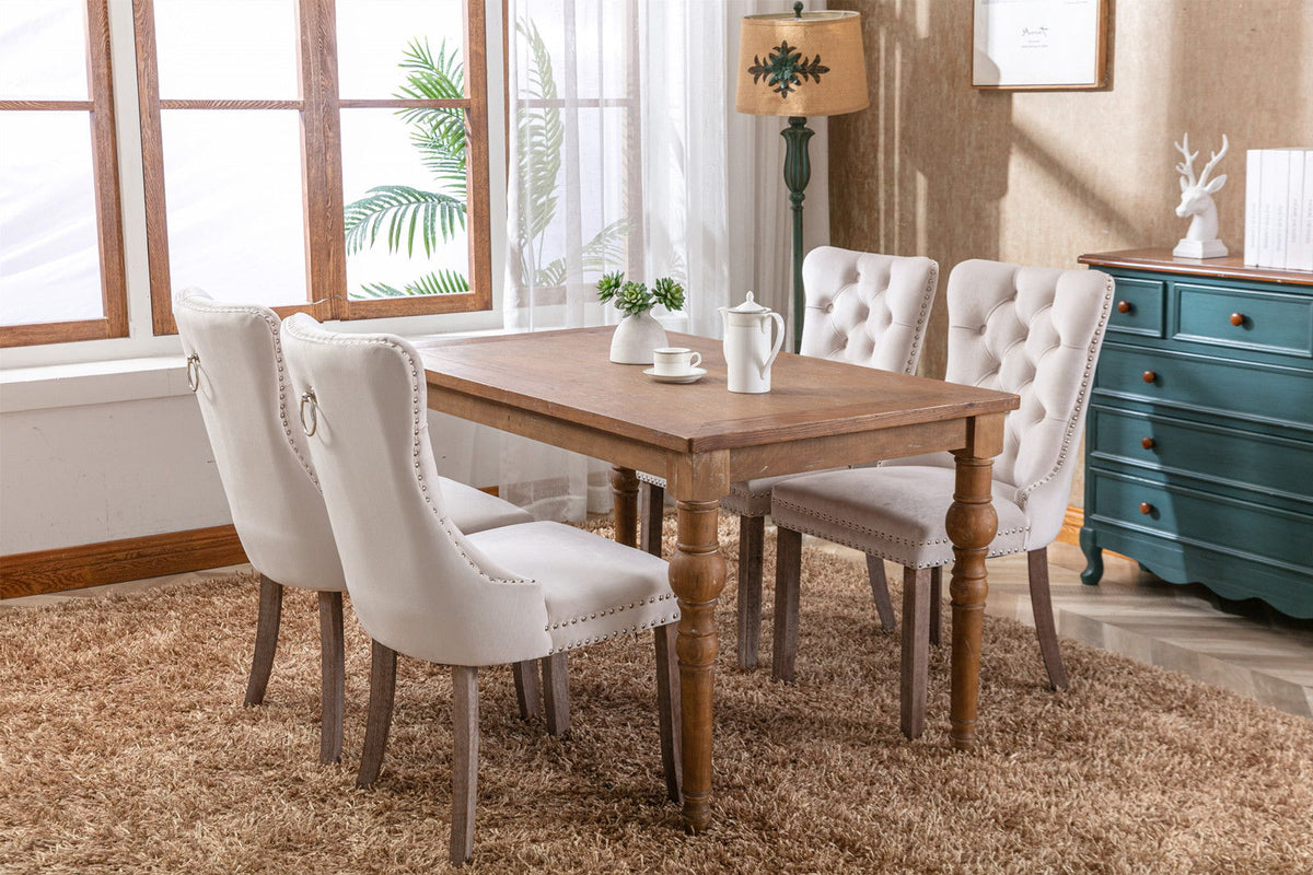 Tufted dining chair set in ivory velvet with nailhead trim; 4 chairs around a rustic wood table on Tampa Home & Garden Store