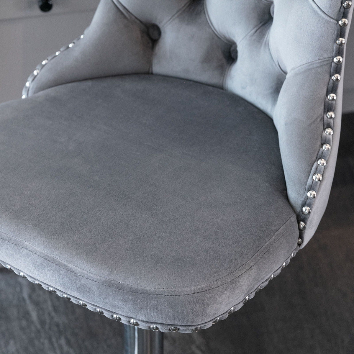 Swivel adjustable-height barstools (set of 2) in grey velvet with chrome nailhead trim along edge on Tampa Home & Garden Store