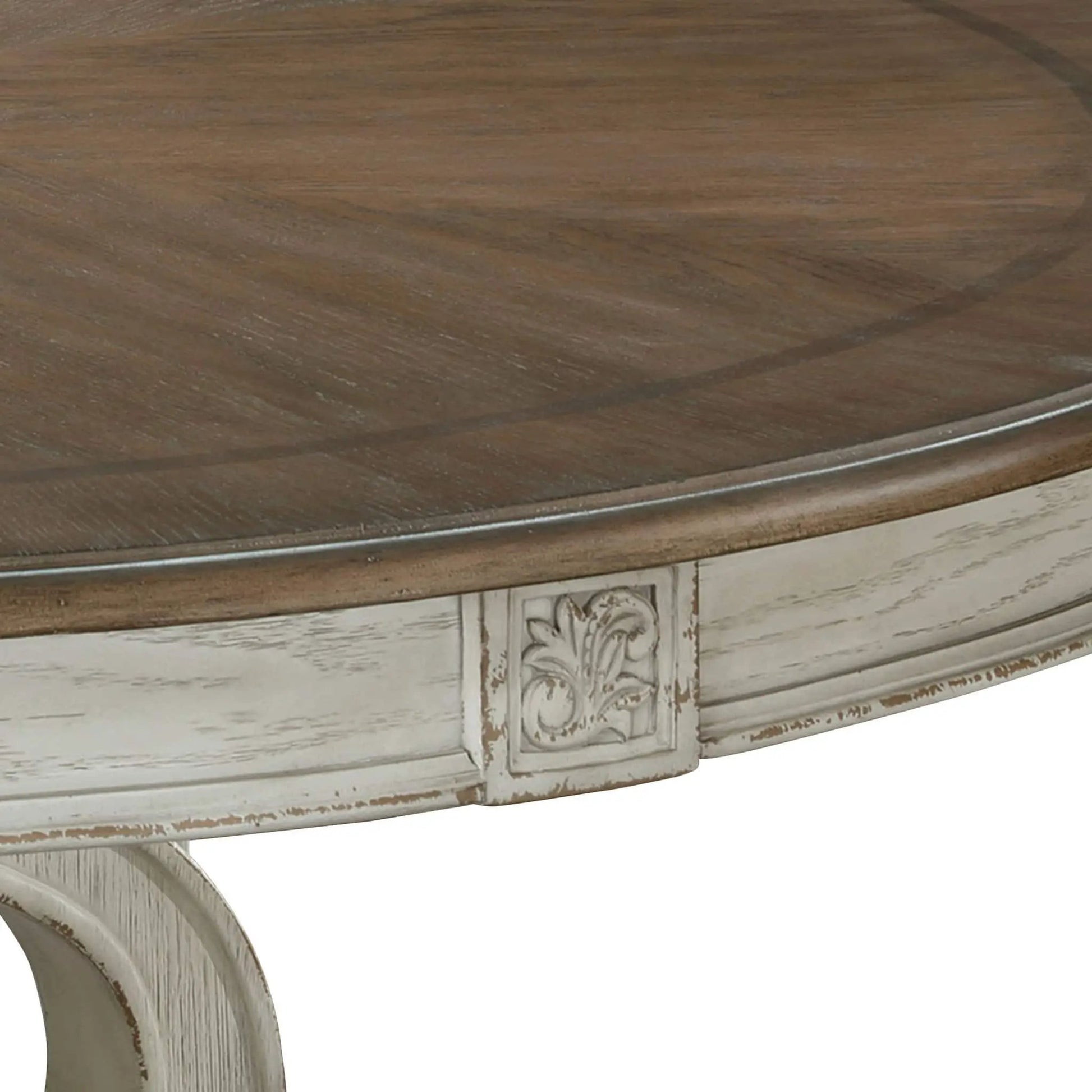 Elegant round dining table with dark wood top and distressed carved pedestal base on Tampa Home & Garden Store