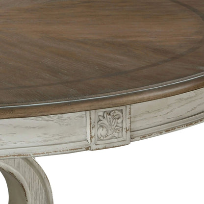 Elegant round dining table with dark wood top and distressed carved pedestal base on Tampa Home & Garden Store