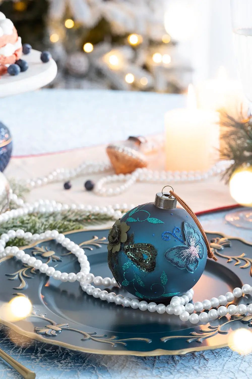Glass teal blue Christmas ball ornament with butterfly glitter design, leather hang loop on Tampa Home & Garden Store