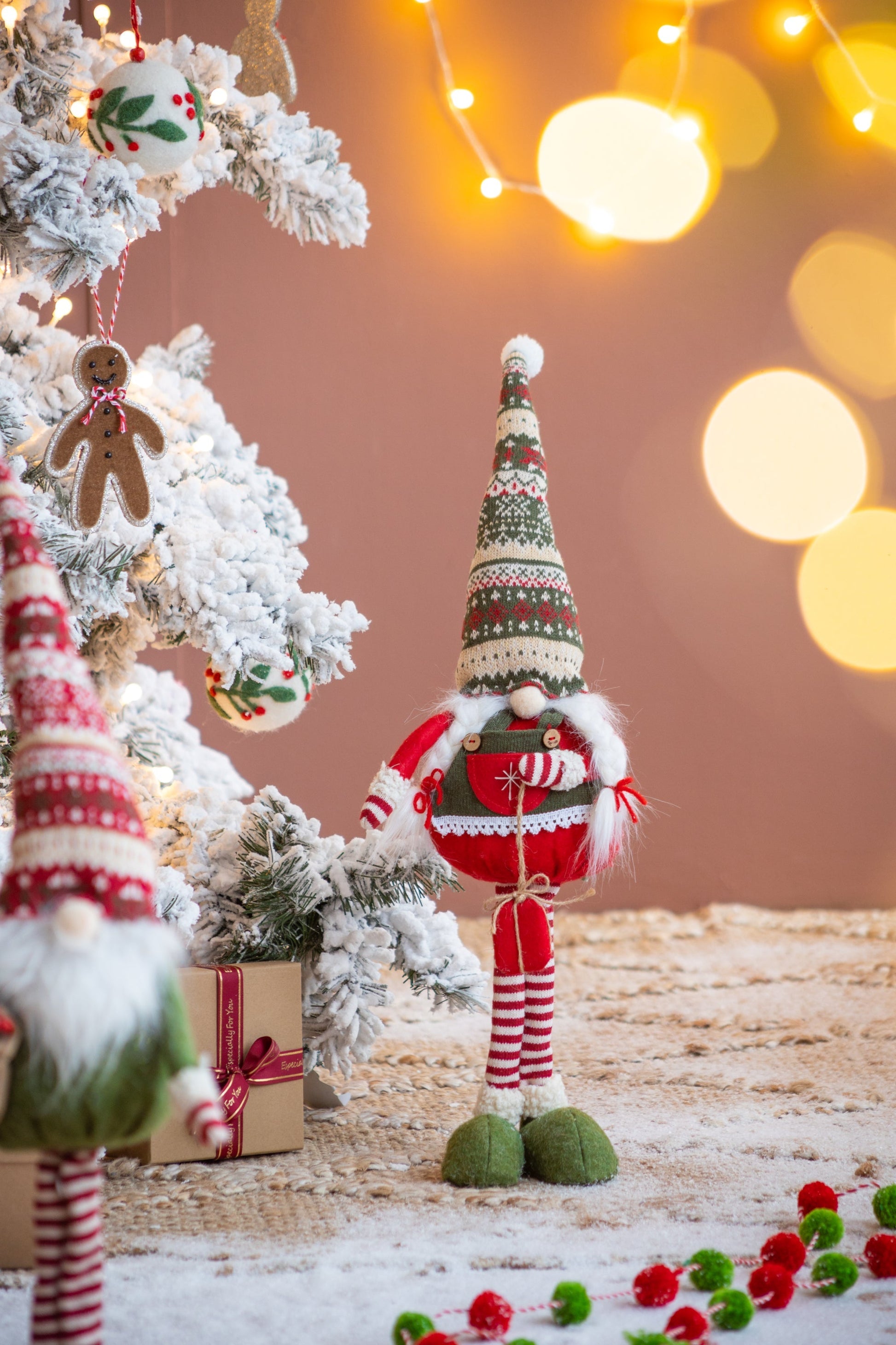 Set of 2 Fabric Standing Holiday Gnomes in red and green outfits beside a snow-dusted tree on Tampa Home & Garden Store