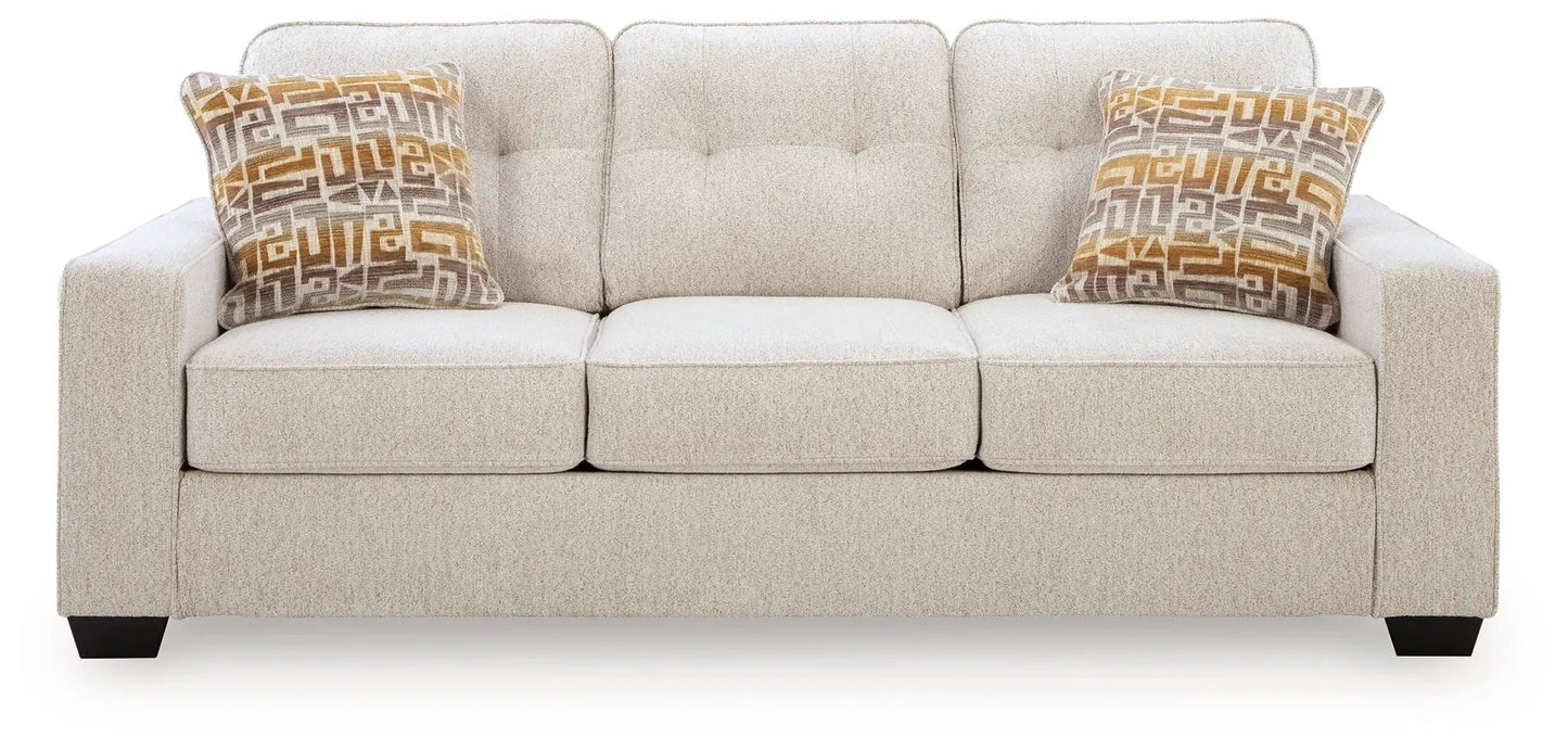 Larimer sofa beige stationary sofa with tufted back and two geometric orange pillows on Tampa Home & Garden Store
