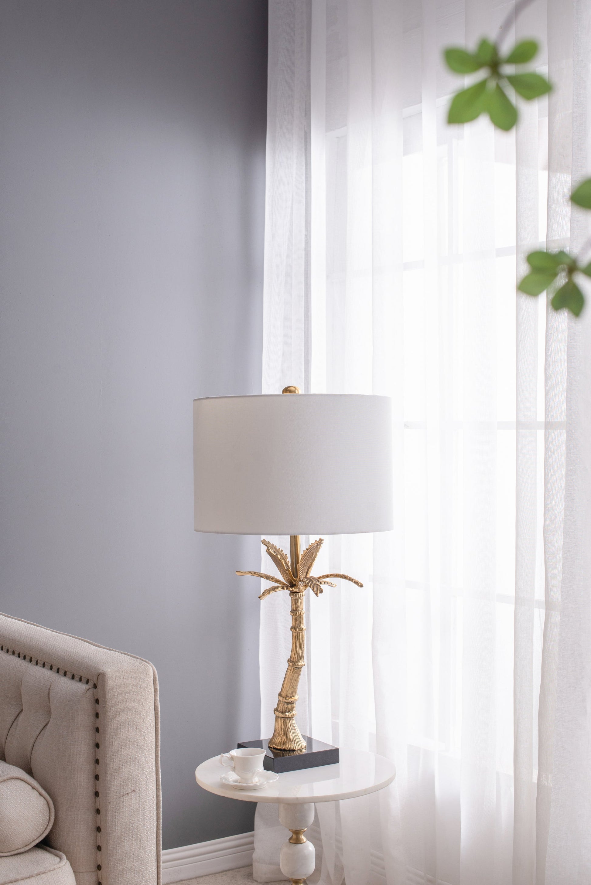 Leaf lamp with gold finish and marble base by HouseOfZazla on a side table beside curtains on Tampa Home & Garden Store