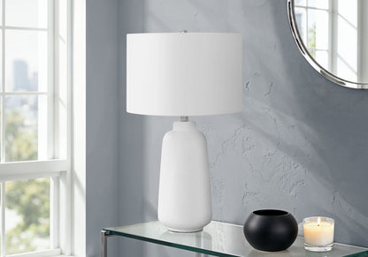 Cream ceramic table lamp with white cylindrical shade in modern style on glass console on Tampa Home & Garden Store