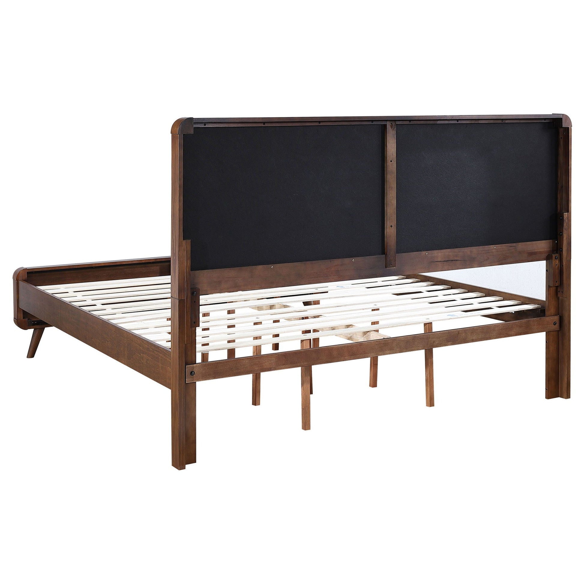 Carson Carrington platform bed with dark upholstered headboard panels and wood frame on Tampa Home & Garden Store