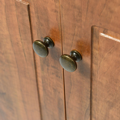Triangle bathroom storage cabinet front close-up in dark wood with round brass knobs on Tampa Home & Garden Store