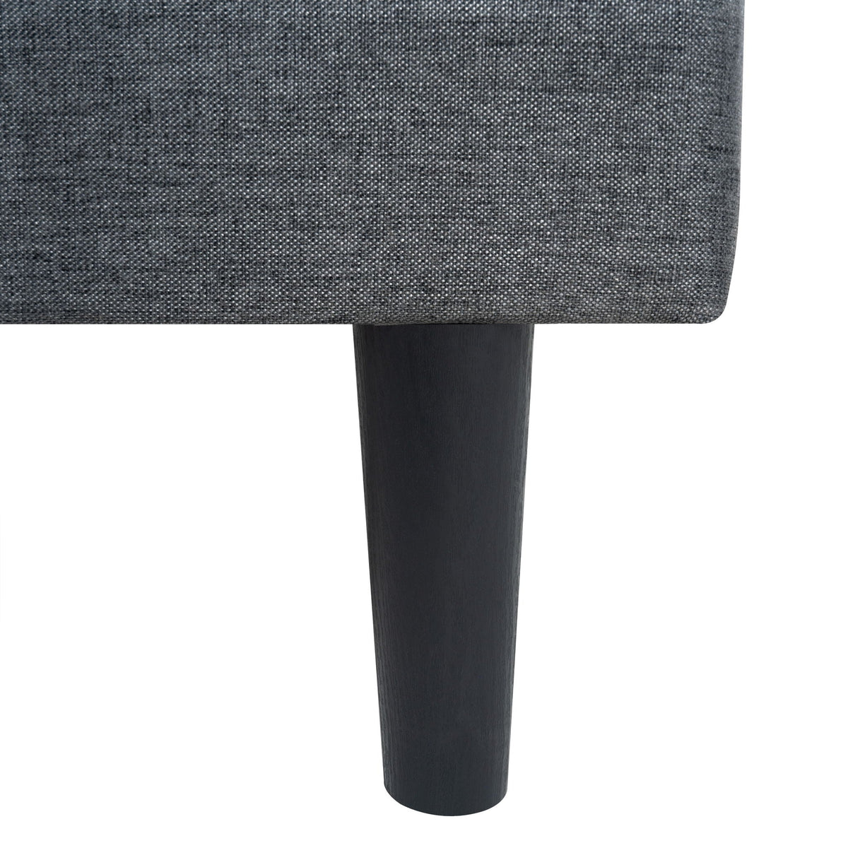 Upholstered bed frame close-up in dark gray linen fabric with black wood leg on Tampa Home & Garden Store