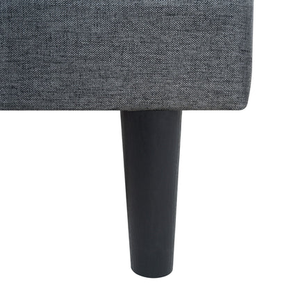 Upholstered bed frame close-up in dark gray linen fabric with black wood leg on Tampa Home & Garden Store
