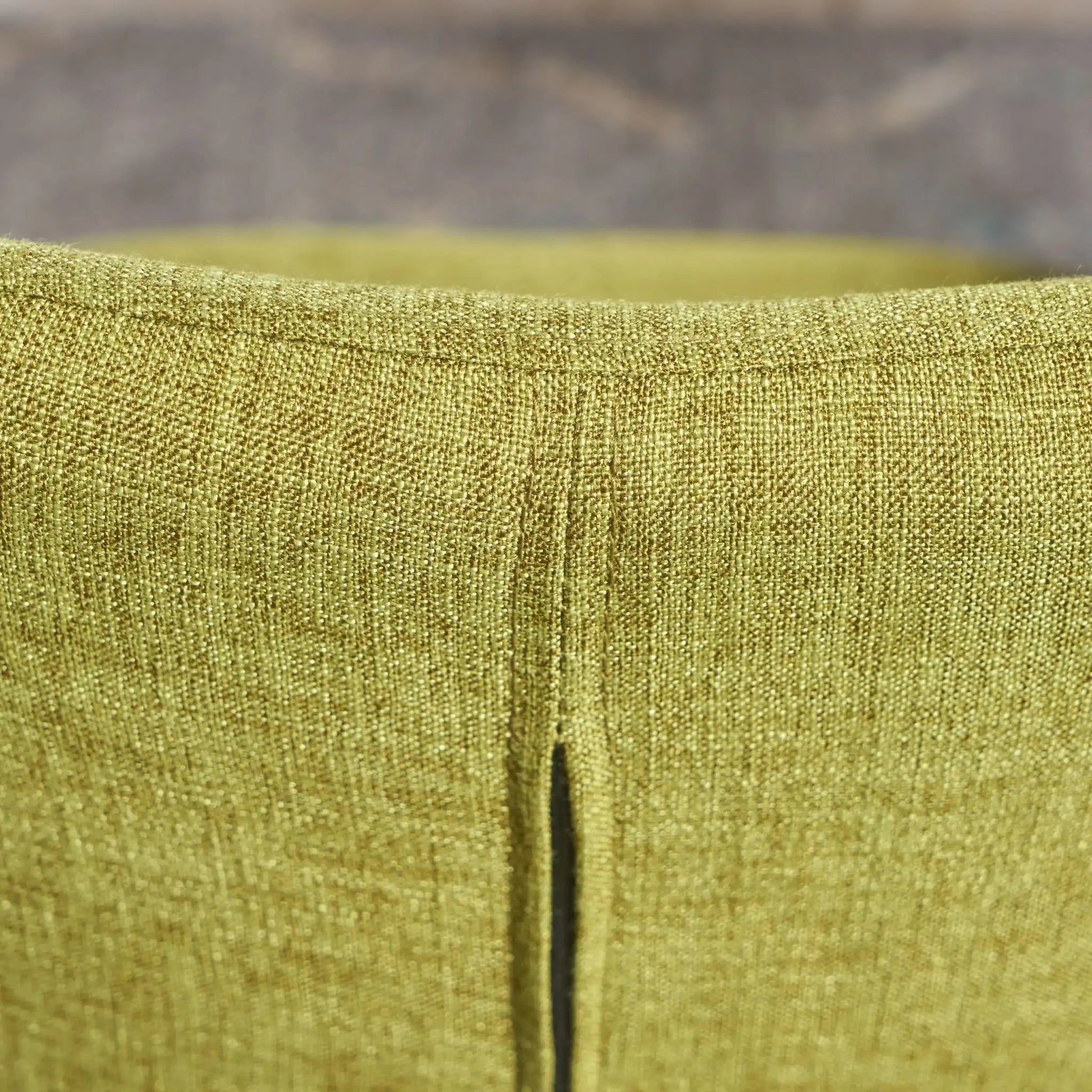 Arm chair upholstery close-up in olive-gold textured fabric with seam on Tampa Home & Garden Store