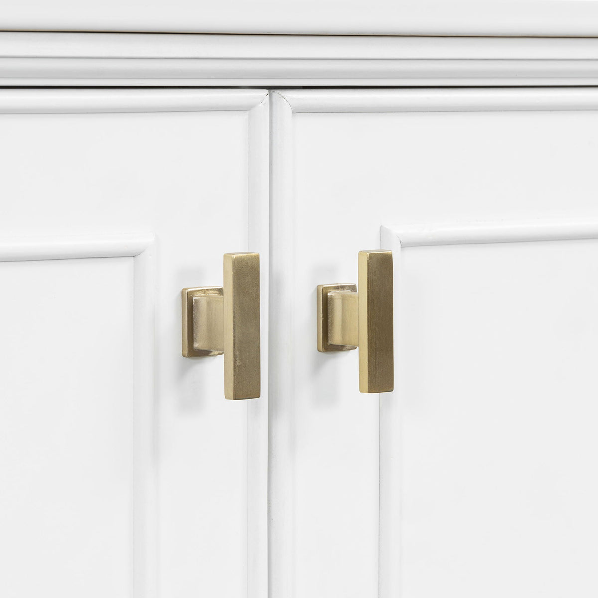White freestanding vanity doors with brass rectangular pulls on Tampa Home & Garden Store