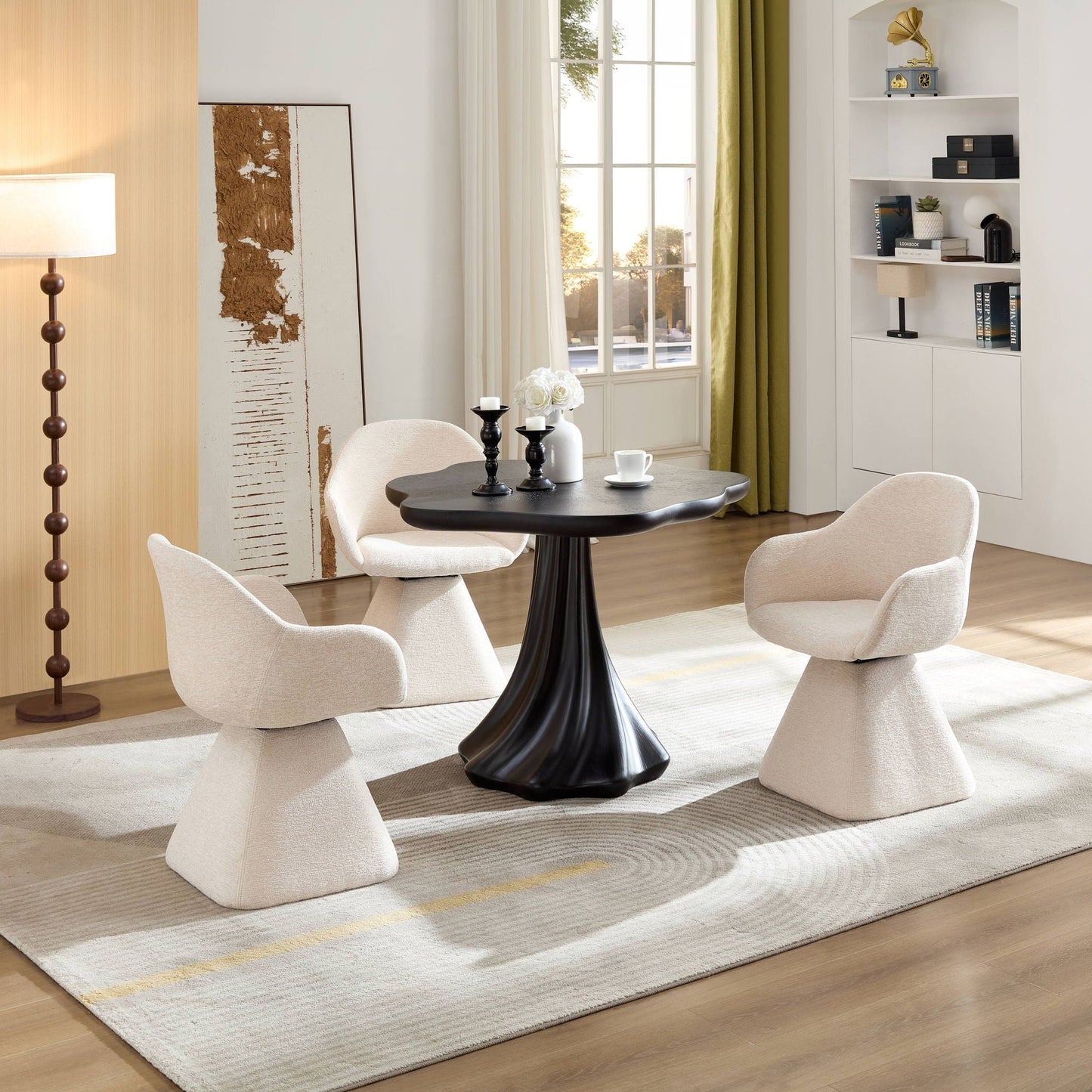 Sculptural round dining table in black with petal pedestal, 4 cream chairs on Tampa Home & Garden Store