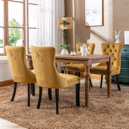Tufted velvet dining chairs set with nailhead trim in mustard, 4 chairs around a wooden table on Tampa Home & Garden Store