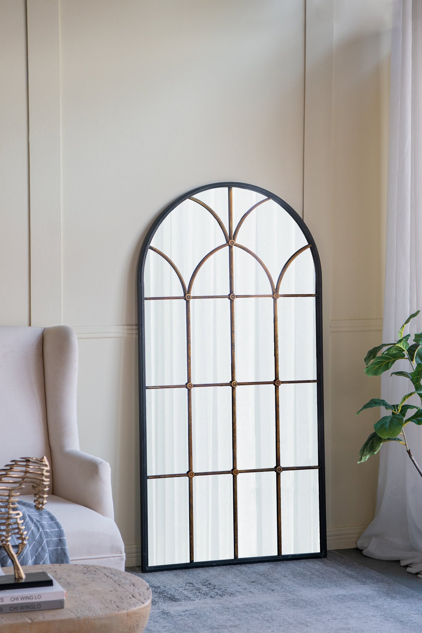 34x65.5' Arched Full-Length Mirror with black frame and gold windowpane grid in a living room on Tampa Home & Garden Store