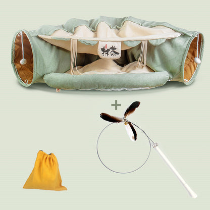 Four Seasons Cat Tunnel Bed in green fabric with beige interior; yellow bag and feather wand on Tampa Home & Garden Store