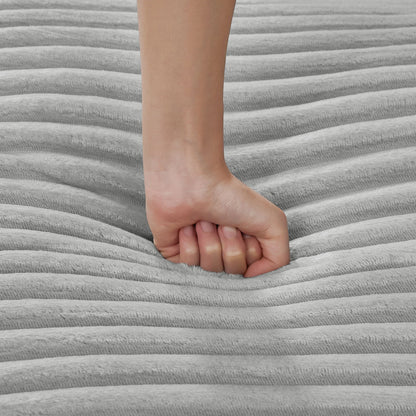 Barefoot resting on soft gray striped fabric with plush texture on Tampa Home & Garden Store