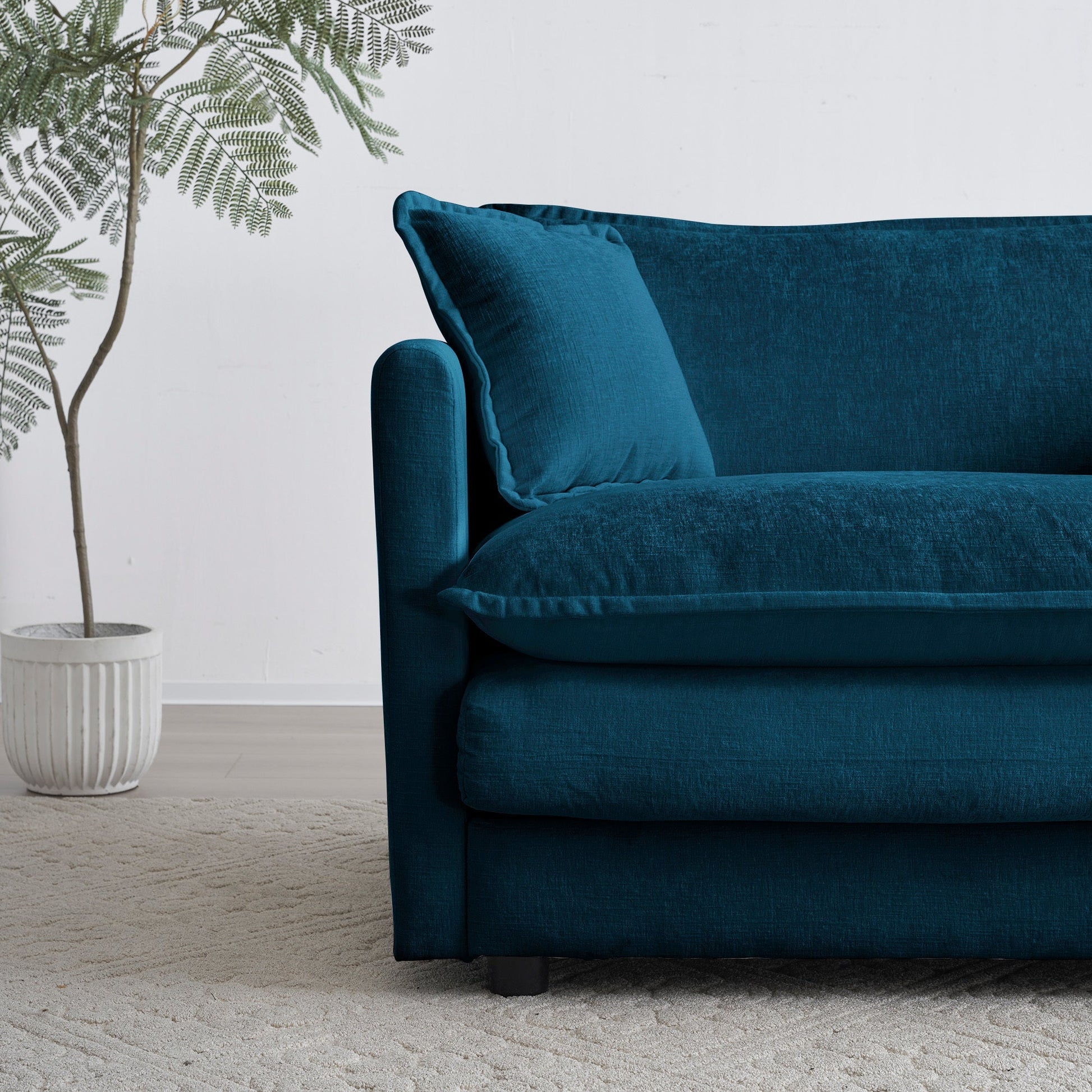 Modular sectional sofa teal velvet with plush cushions beside a white planter on Tampa Home & Garden Store