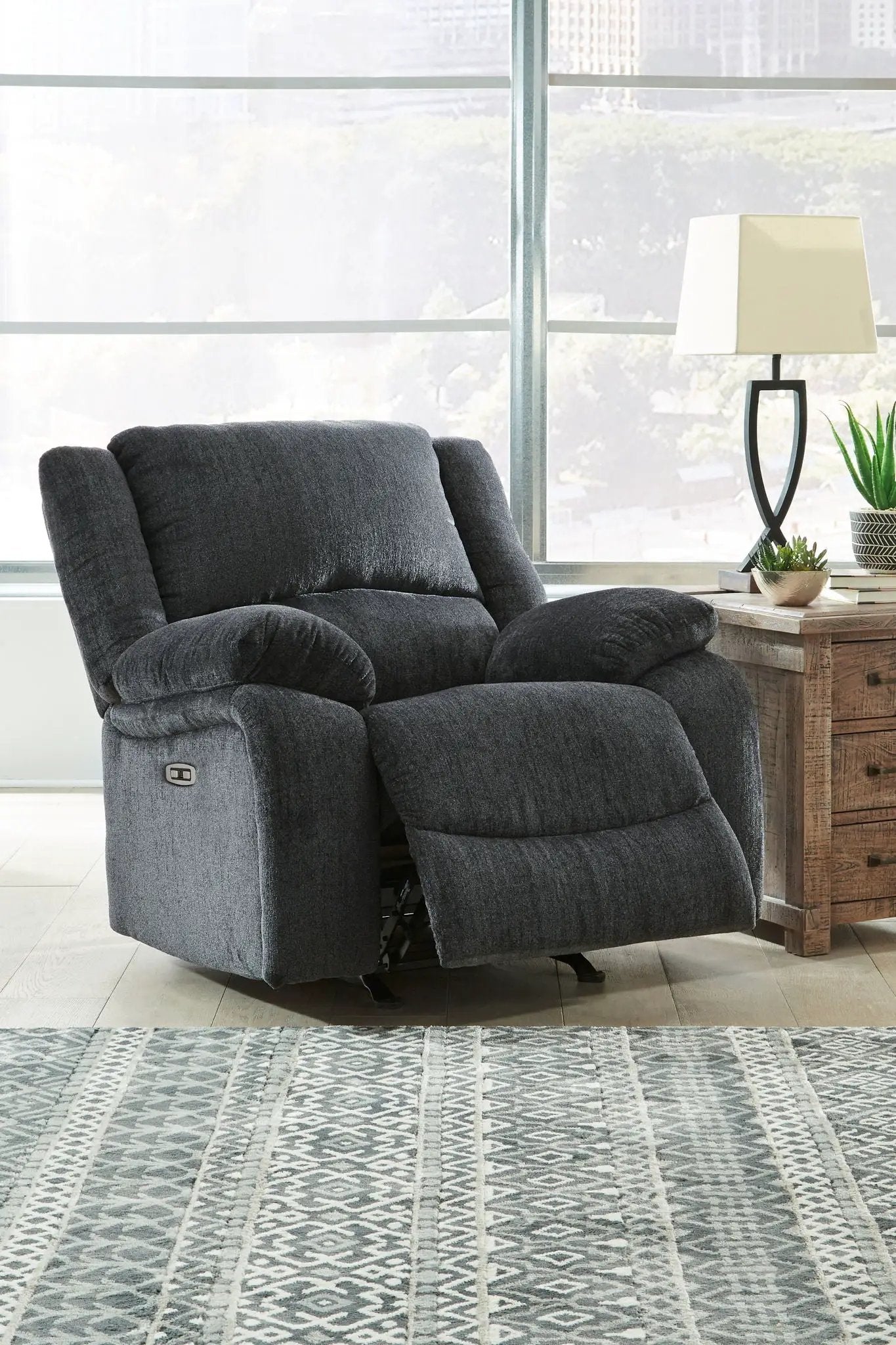 Draycoll rocker recliner in dark gray fabric with plush cushions on Tampa Home & Garden Store