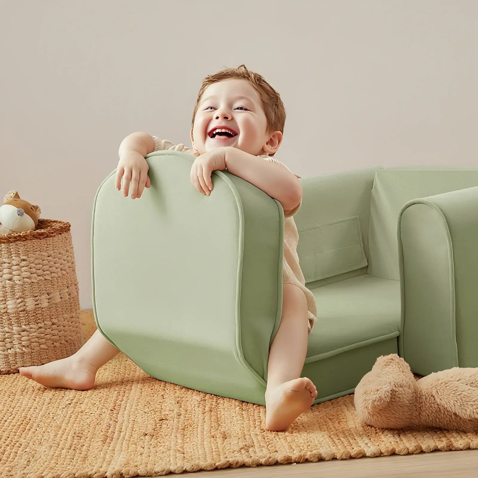 Tiny Land GentleSnug Kid Chair mint green with rounded arms, child seated on play sofa set on Tampa Home & Garden Store