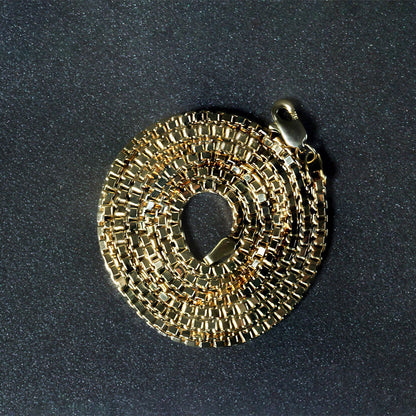 2.0mm 14k yellow gold box chain necklace, coiled with lobster clasp on dark background on Tampa Home & Garden Store