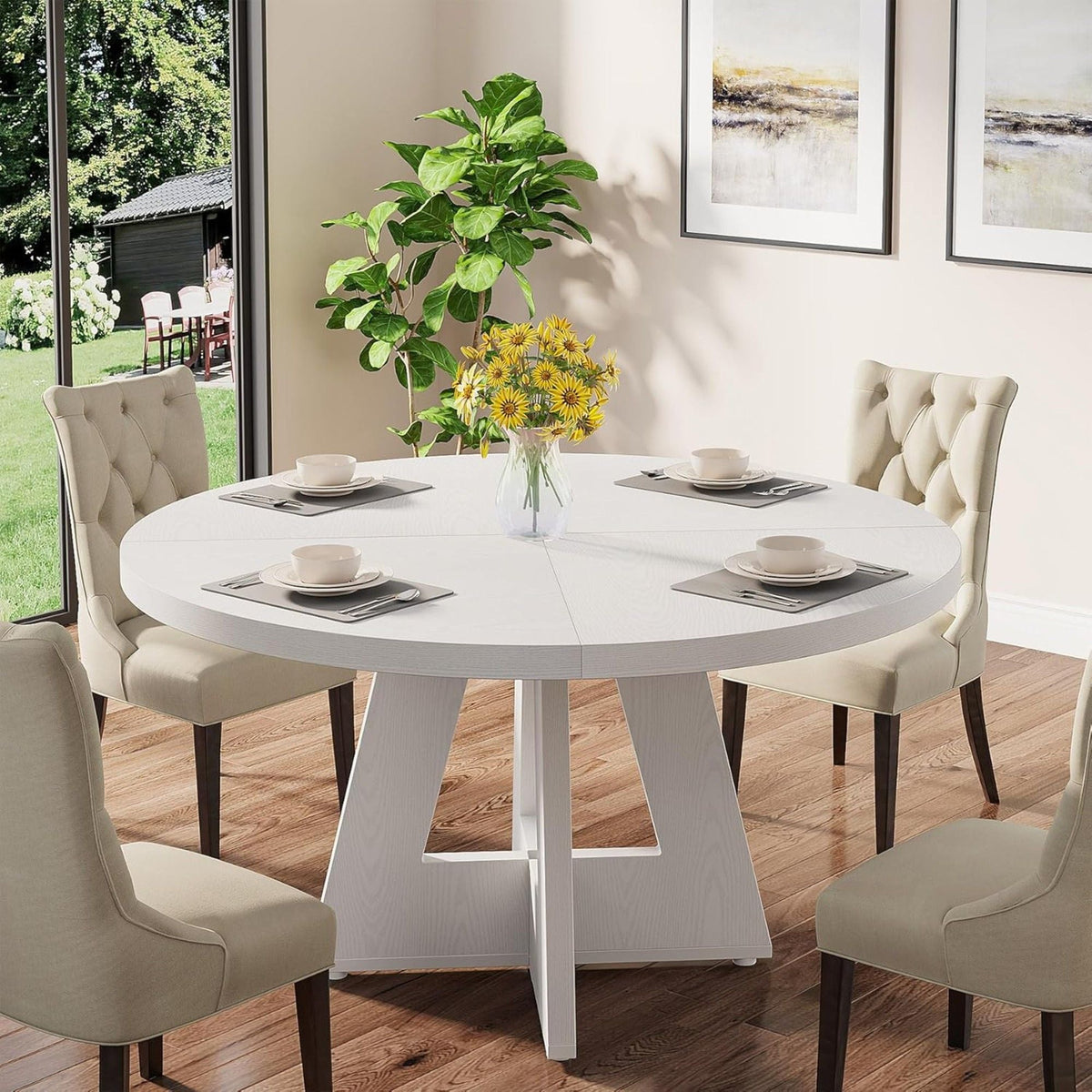 Round dining cross-base kitchen table in white with beige tufted chairs in a sunlit dining room on Tampa Home & Garden Store