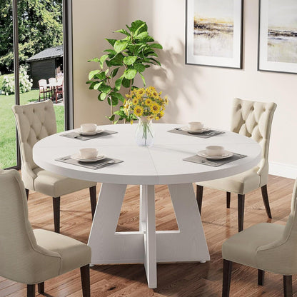 Round dining cross-base kitchen table in white with beige tufted chairs in a sunlit dining room on Tampa Home & Garden Store