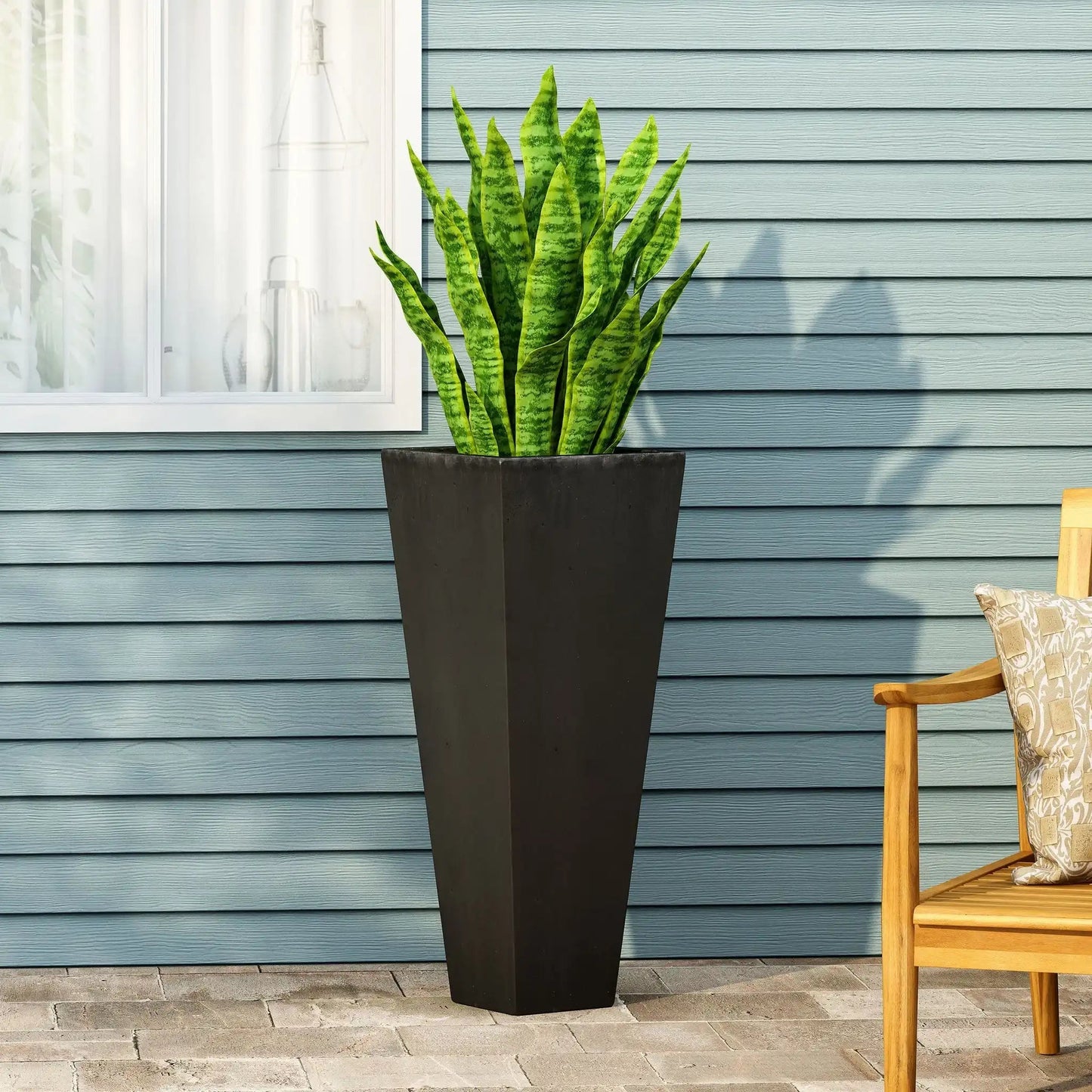 Outdoor Modern Cast Stone Planter in dark gray with tall silhouette and snake plant on Tampa Home & Garden Store
