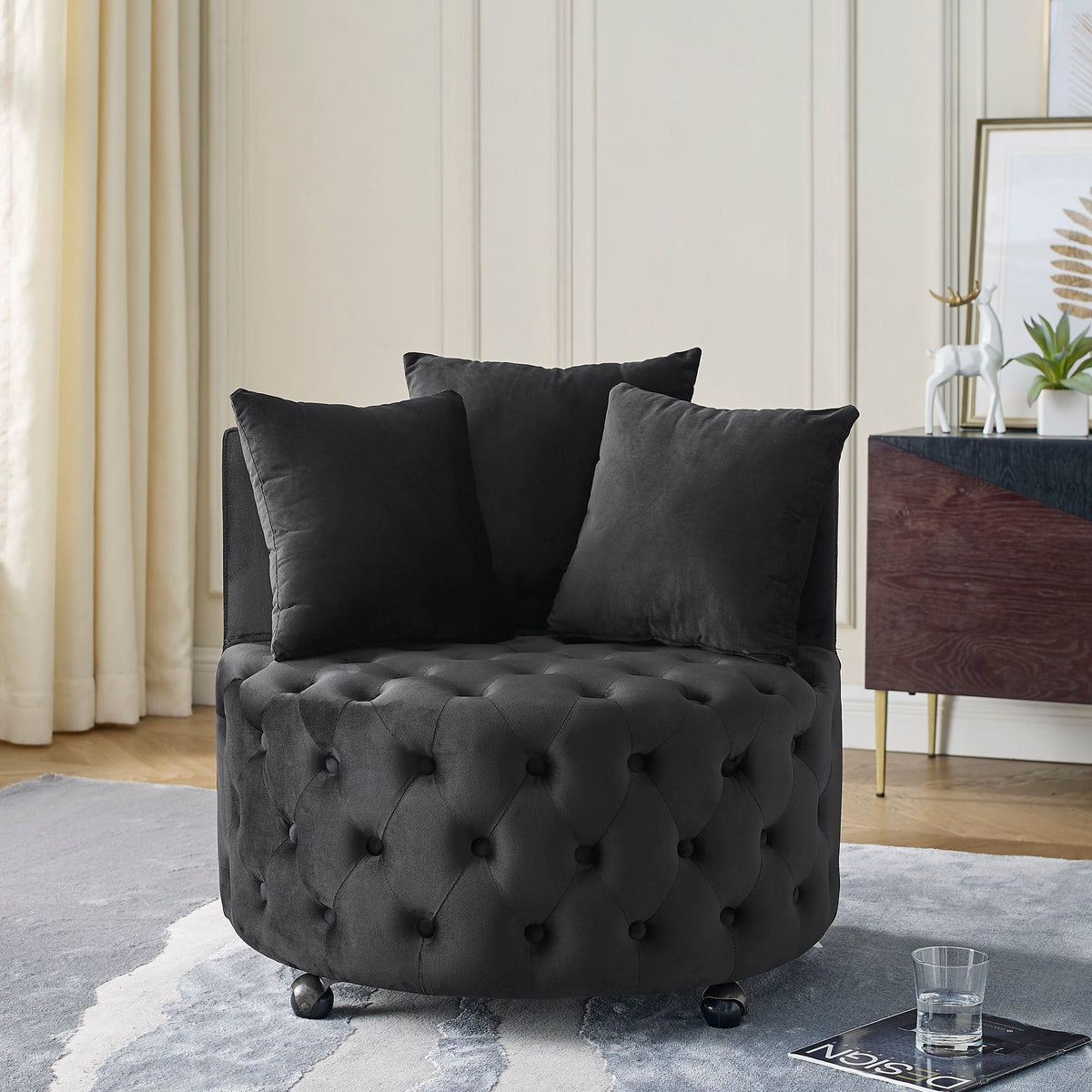 Black tufted round swivel chair with button upholstery and wheeled base on Tampa Home & Garden Store