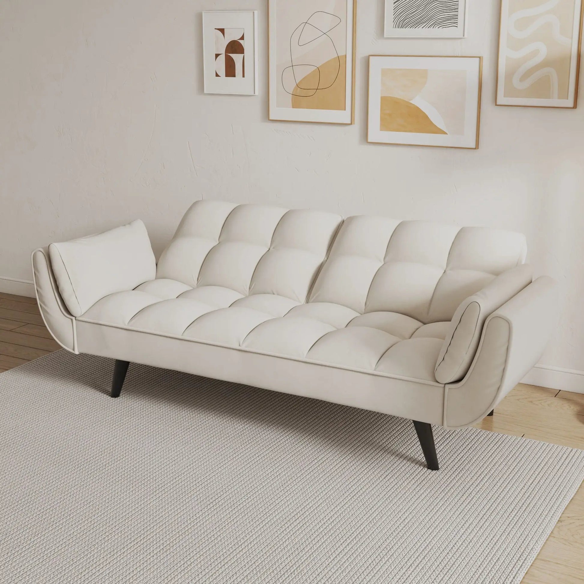 Cream tufted faux leather futon sofa with two armrests and black legs on Tampa Home & Garden Store
