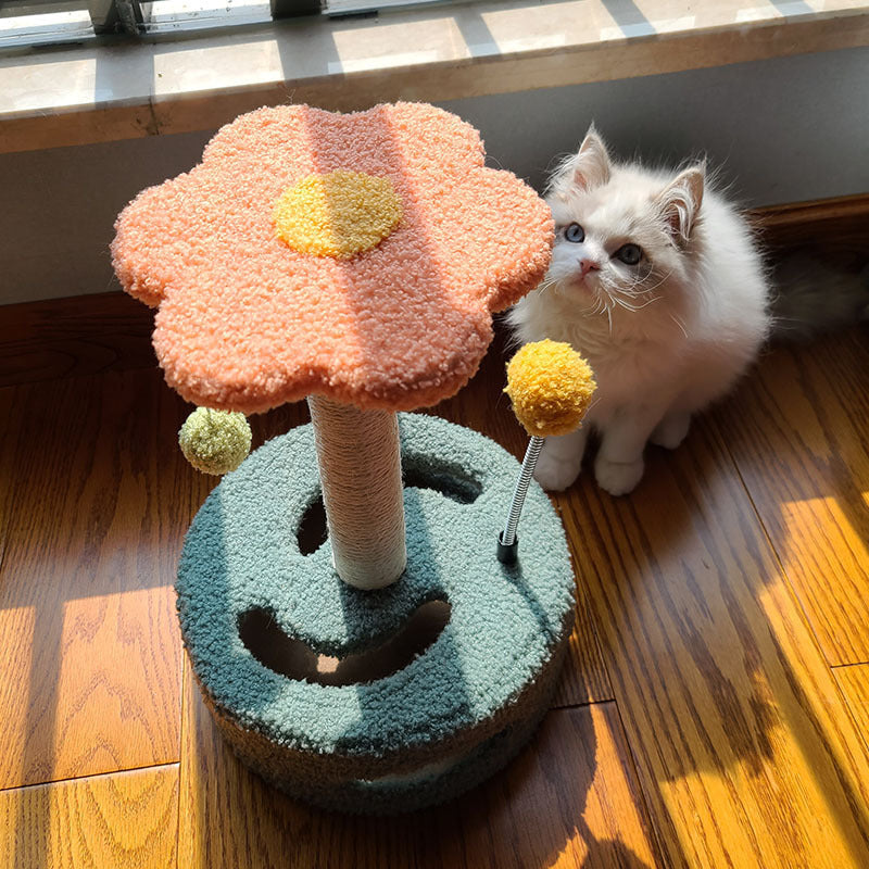 Cat scratch tree by Sell My Stuff with orange flower top and turquoise base beside a white cat on Tampa Home & Garden Store