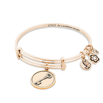 Lolo Key Bangle by Lauren G Adams in rose gold with key charm and three decorative charms on Tampa Home & Garden Store
