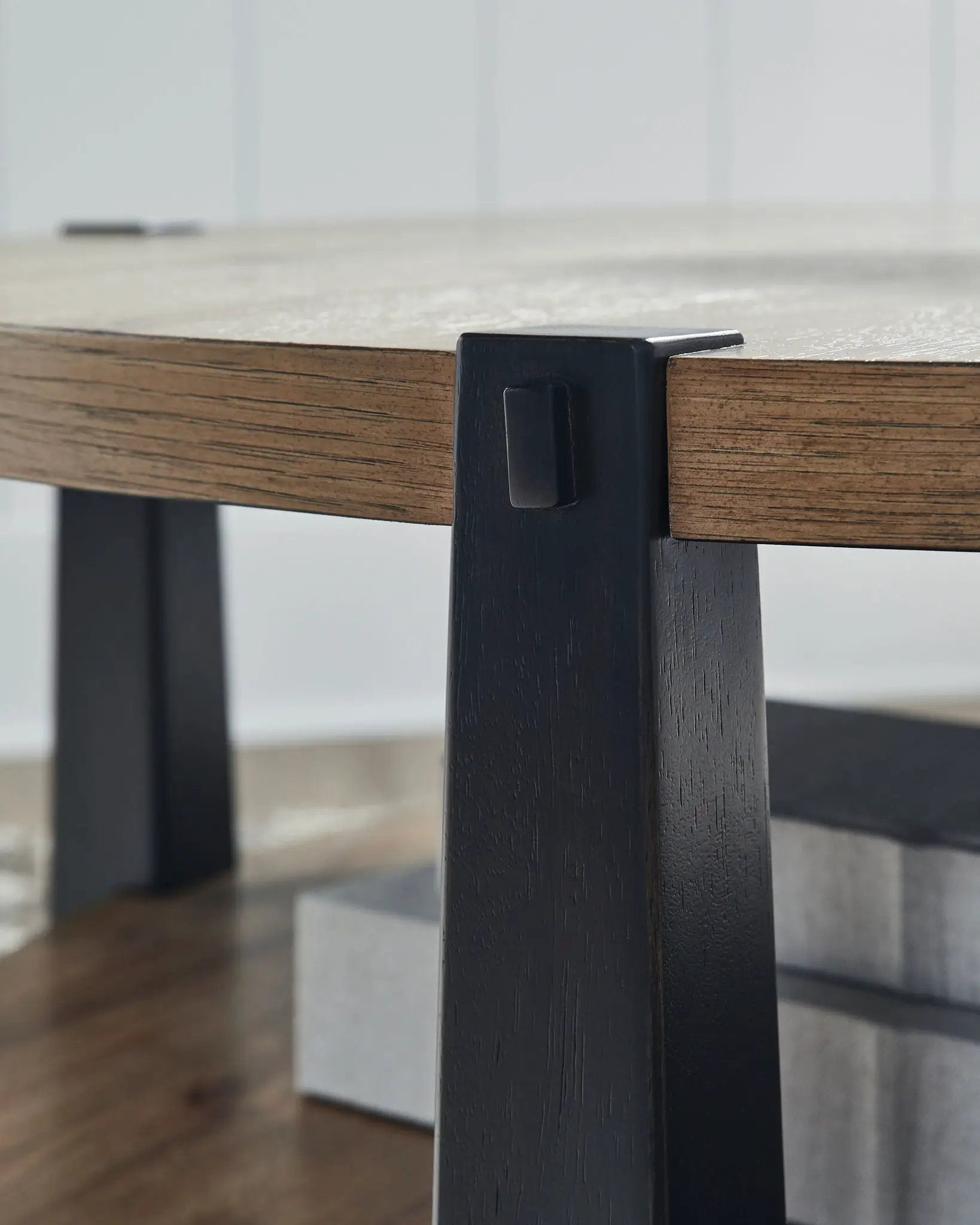 Ridgester - Round Table from Unique Piece Furniture; dark wood top with black metal frame close-up on Tampa Home & Garden Store