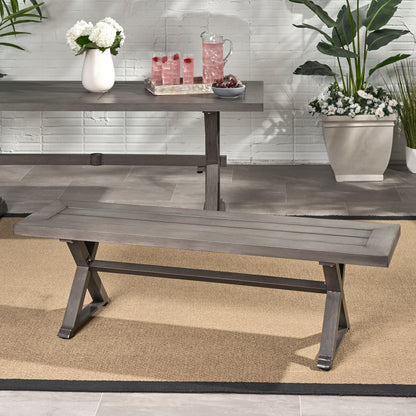 Modern dark gray aluminum outdoor dining bench with X base on a deck on Tampa Home & Garden Store