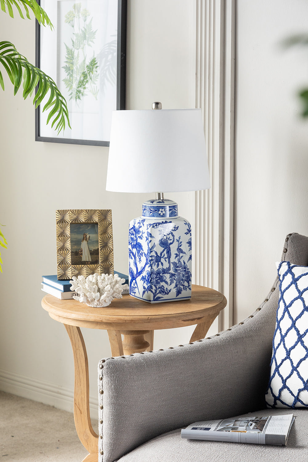 13x25' Blue and White Ceramic Vase Lamp with white shade on a round wooden side table on Tampa Home & Garden Store