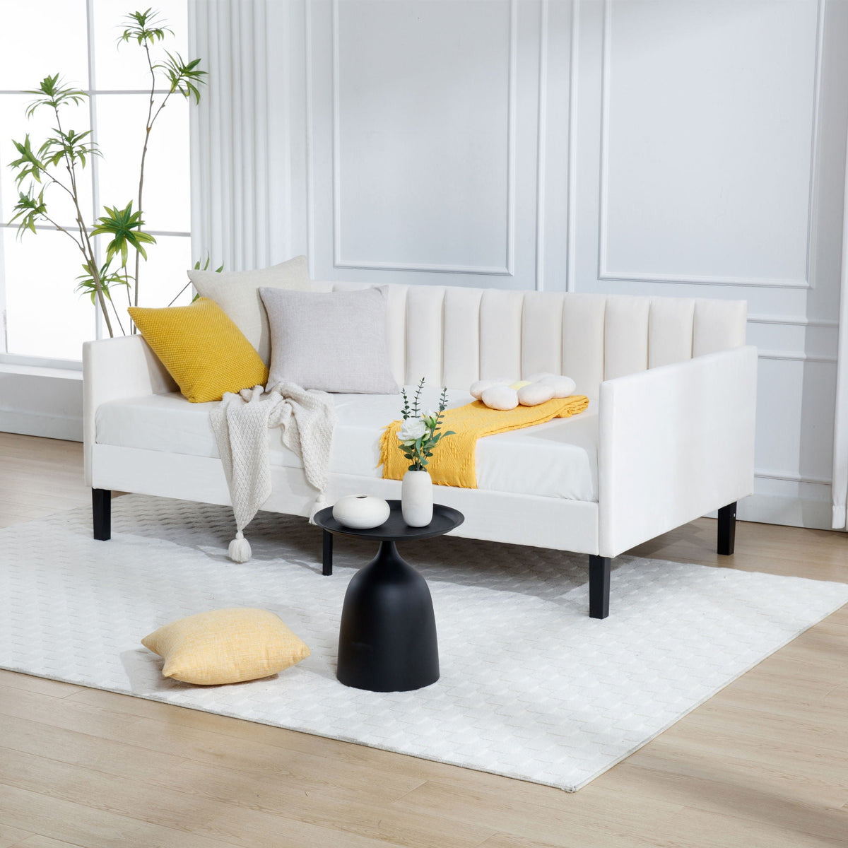 Elena Boucle Daybed with ribbed tufted backrest in white fabric; yellow pillow and gray throw on Tampa Home & Garden Store