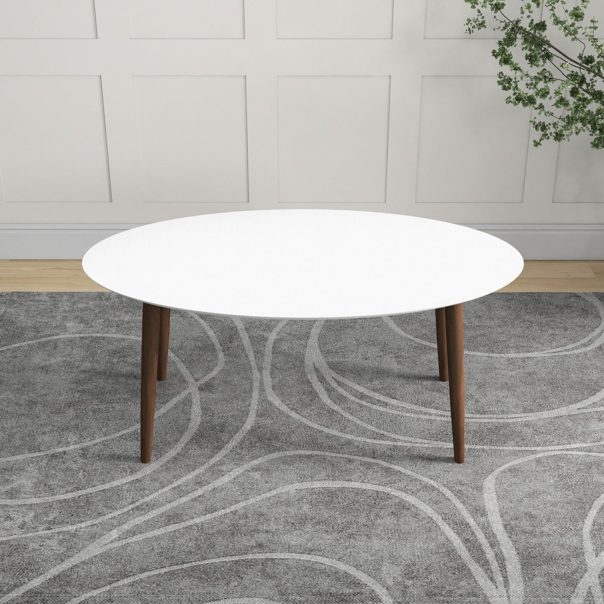 Mid-century modern oval dining table with white top and solid wood legs on Tampa Home & Garden Store