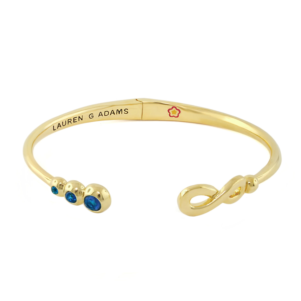 Open Arms Eternity Bangle gold-tone hinged bracelet with blue gemstones, Lauren G Adams brand flower emblem on Tampa Home & Garden Store