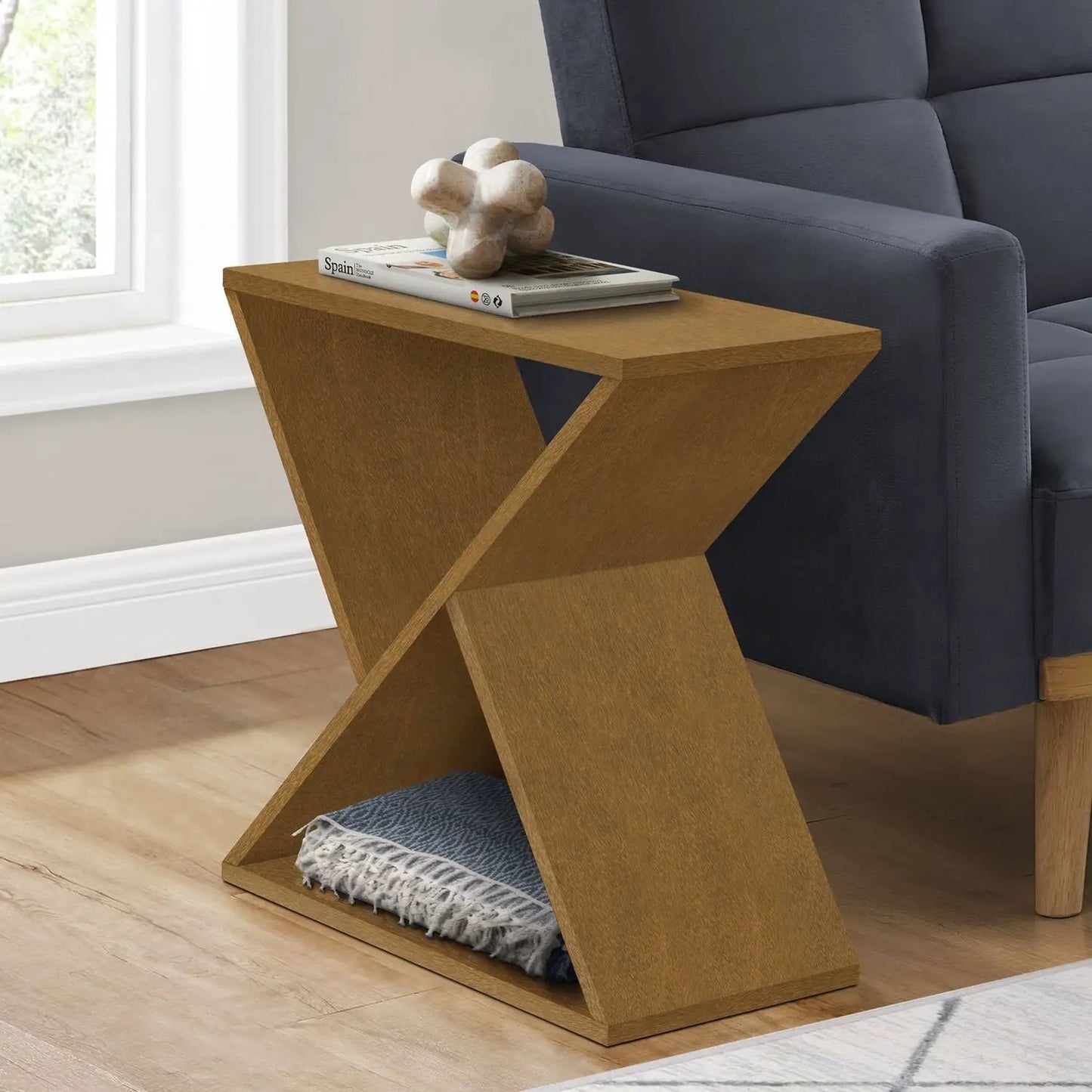 Accent Side Table in warm oak with geometric X-leg design, magazines beside a navy sofa on Tampa Home & Garden Store