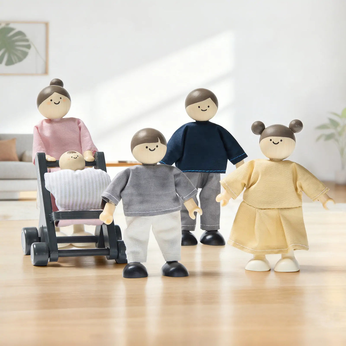 Dollhouse dolls by Tiny Land INC; five wooden figures in pastel outfits with a baby in stroller on Tampa Home & Garden Store