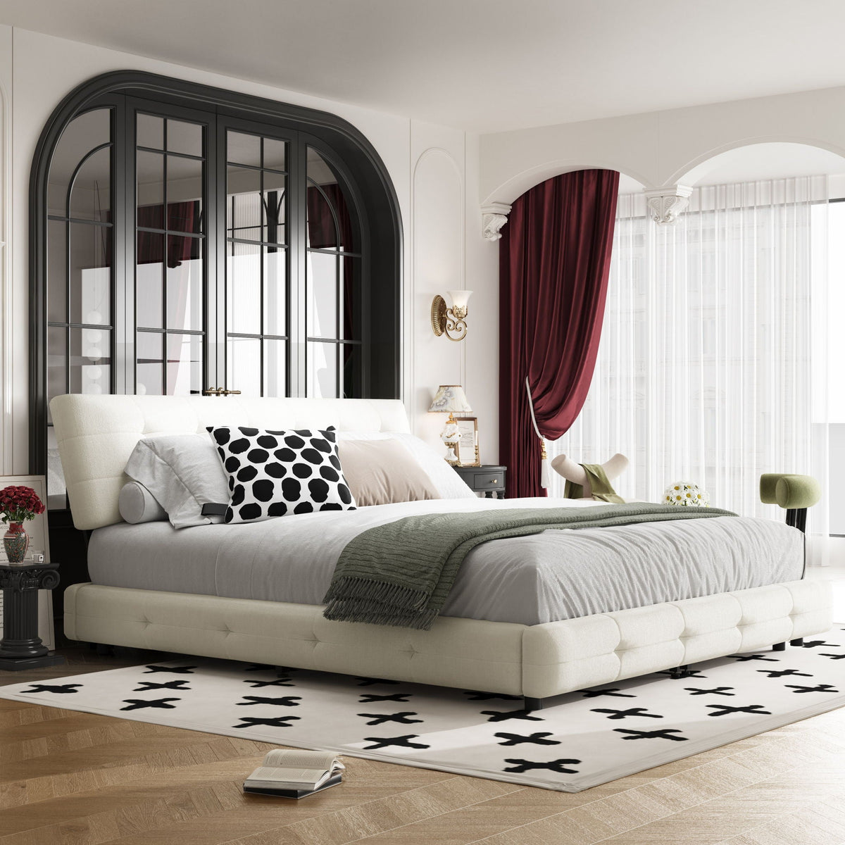 Tufted white upholstered bed with gray bedding and a black polka dot pillow in luxe bedroom on Tampa Home & Garden Store